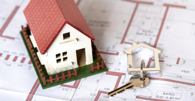 high-view-house-with-garden-and-keys-on-blueprint